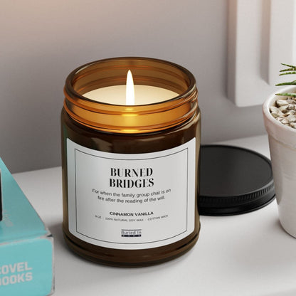 Burned Bridges candle lit on a windowsill