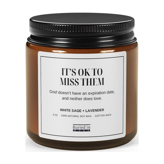It's OK to Miss Them soy candle in an amber glass jar
