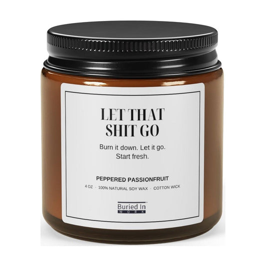 Let That Shit Go soy candle in an amber glass jar