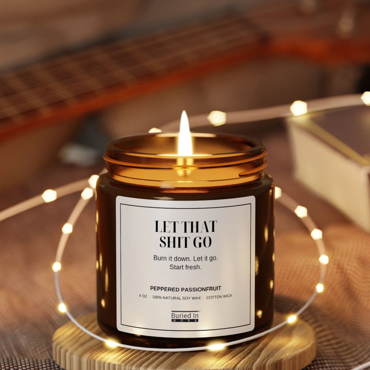 Let That Shit Go candle lit, with string lights