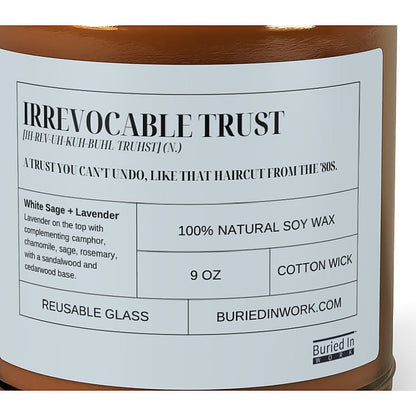 Close-up of the Irrevocable Trust candle label: a trust you can't undo, like that haircut from the 80s. White Sage and Lavender, 100% natural soy wax, cotton wick, reusable glass