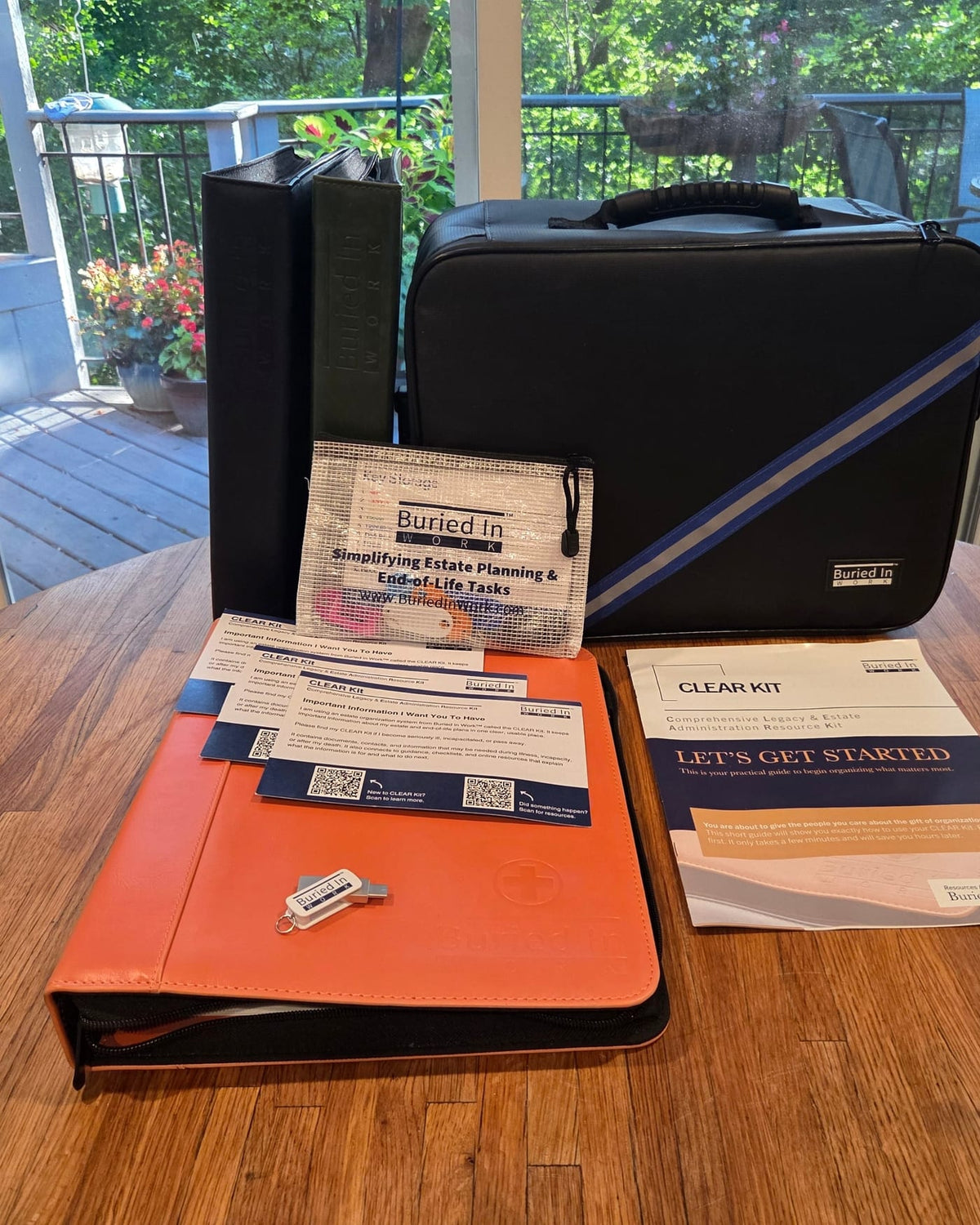 A CLEAR Kit laid out on a table: the case, binders, cards and Getting Started booklet